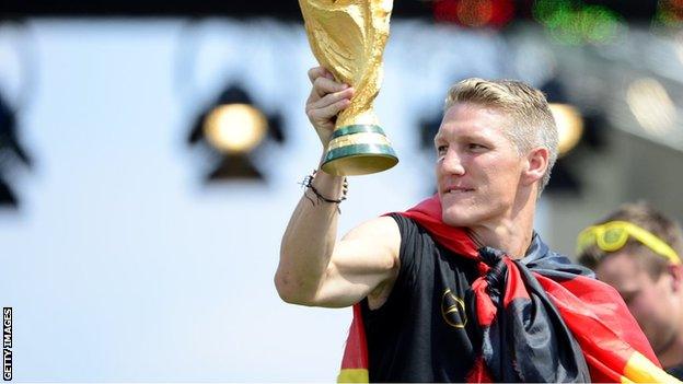 Bastian Schweinsteiger holds aloft the 2014 World Cup