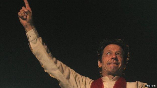 Imran Khan, cricketer-turned-opposition politician and chairman of the Pakistan Tehreek-e-Insaf (PTI) political party, gestures to his supporters during the Freedom March in Islamabad August 18, 2014.