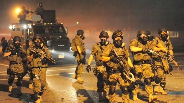 Police in riot gear patrol the streets in Ferguson, Missouri - 18 August 2014