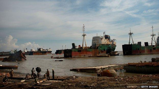 Ship breakers work on dismantling a ship in the port city of Chittagong, Bangladesh