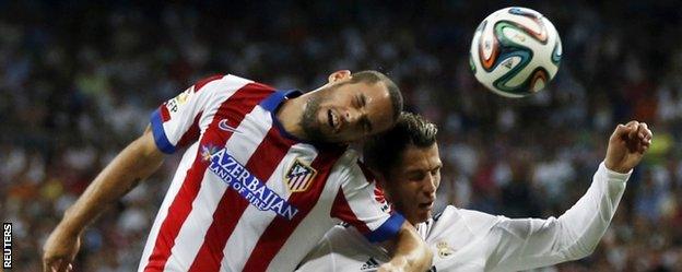 Cristiano Ronaldo and Atletico Madrid's Mario Suarez