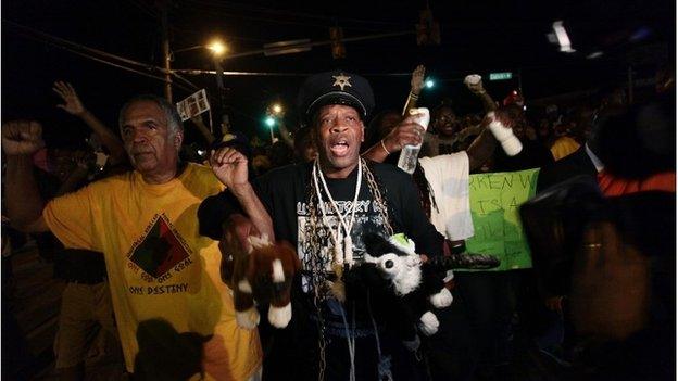 Demonstrators protest the shooting death of Michael Brown, in Ferguson, Missouri August 19