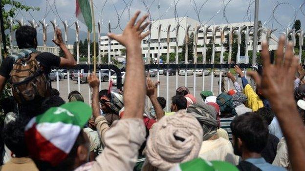 Pakistani supporters of Canada-based preacher Tahirul Qadri gather in front of the Parliament during the "Revolution March" protest in Islamabad on 20 August 2014