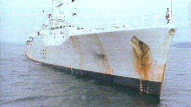 HMS Plymouth showing bomb damage on side of ship