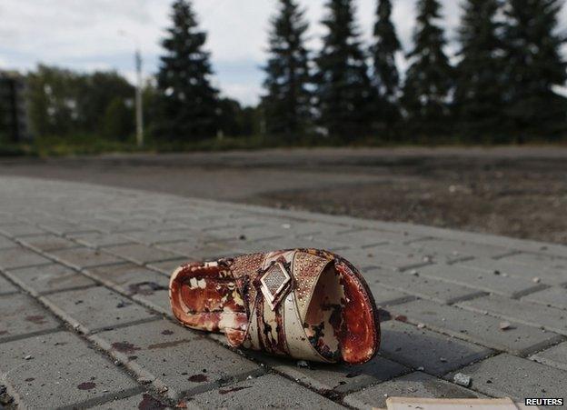 A bloodstained sandal lies on a street in Makiika, near Donetsk, 19 August