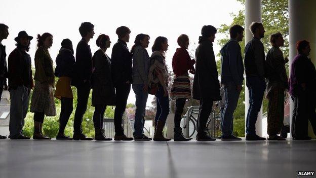 Silhouette of people waiting in a queue