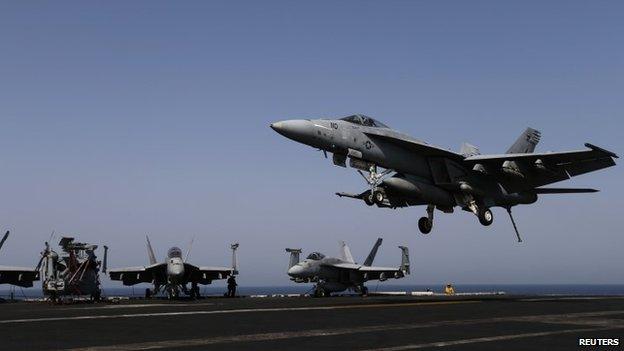 A F/A-18E Super Hornet of Strike Fighter Squadron (VFA-31) comes in to land onboard the flight deck of the aircraft carrier USS George HW Bush (CVN 77), in the Gulf 12 August 2014