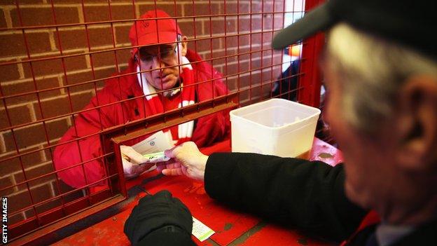 A football fan at the turnstiles