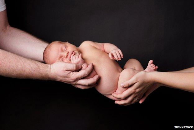 Baby being handed over