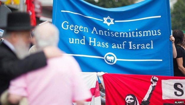 Pro Israel activists hold a banner reading 'Against Anti-Semitism and hate of Israel' at a demonstration as part of Quds Day in Berlin, Germany, 25 July 2014