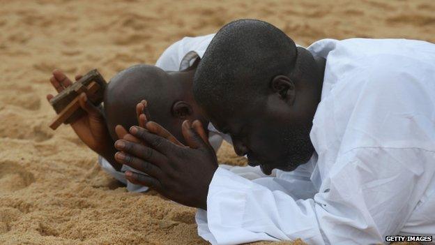 Liberians pray on the beach on 20 August 2014 in Monrovia for help in dealing with the Ebola crisis