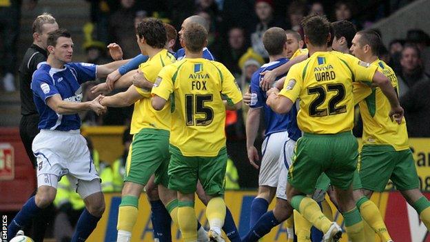 Norwich City and Ipswich Town players tussle