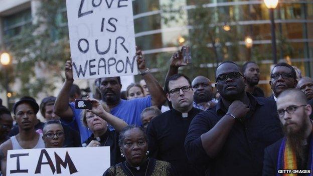 A group of pastors, clergy and protesters stand outside the office building of St. Louis County Prosecutor Bob McCullough on August 20, 2014 in Clayton, Missouri, demanding justice in the police shooting of Michael Brown.