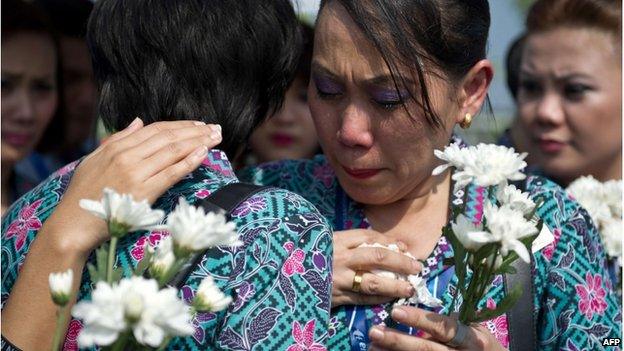 Malaysia Airlines flight attendants cry during the arrival of the coffins at Kuala Lumpur airport. Photo: 22 August 2014