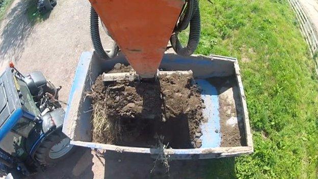 River silt being put in to the back of a lorry