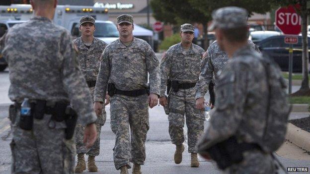 National Guard troops walk through a Ferguson street