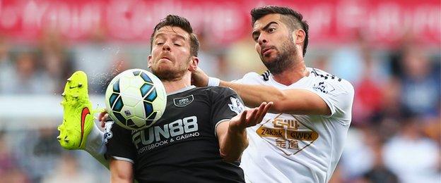 Burnley's summer signing Lukas Jutkiewicz battles for the ball with Jordi Amat