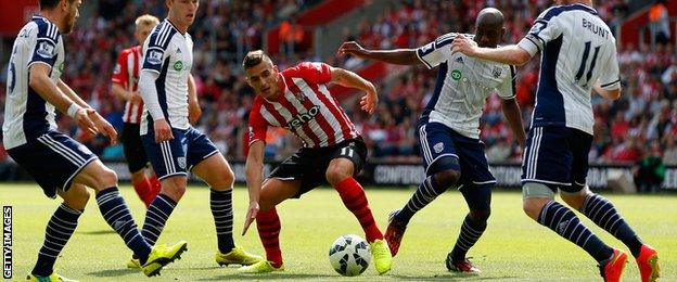 Dusan Tadic of Southampton (centre) tries to find a way through the West Brom defence