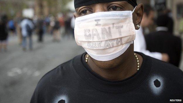 A protester wearing an "I Can't Breathe" face mask takes part in the "We Will Not Go Back" march and rally for Eric Garner in the Staten Island borough of New York (23 August 2014)