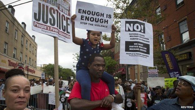 People take part in the "We Will Not Go Back" march and rally for Eric Garner in the Staten Island borough of New York (23 August 2014)