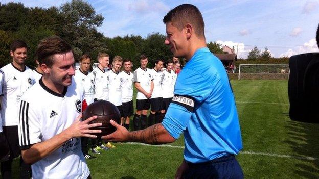 Newark captain Lewis Poole swaps pendants with FC Emmendingen captain