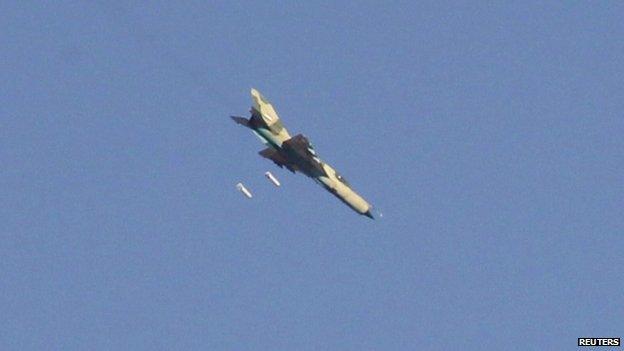 A warplane operated by forces of Syria's President Bashar Al-Assad carries out what activists said was an air raid around al-Tabqa military base at a government-controlled airport that is surrounded by militants, west of Raqqa city, August 21, 2014