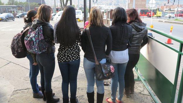 Police officers who are part of Bogota's anti-groping squad pose for pictures in August 2014