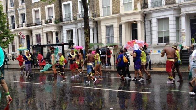 Carnival goers brave the wet weather in Notting Hill on Bank Holiday Monday