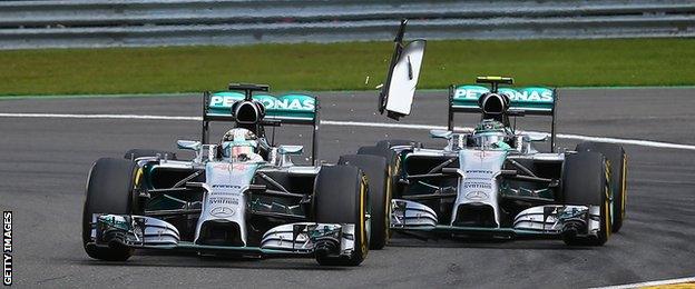 Rosberg (right) clips the back of Hamilton's car