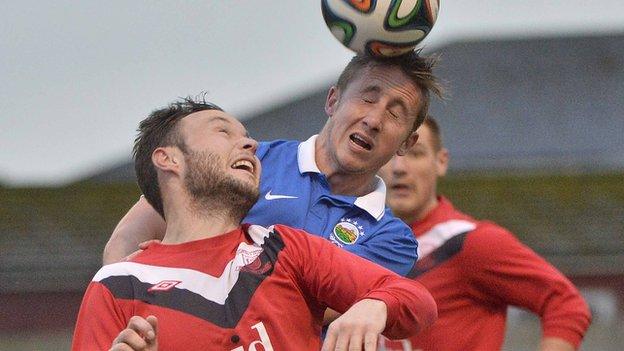 Ballyclare's Andrew Doyle challenges Linfield's Michael Carvill