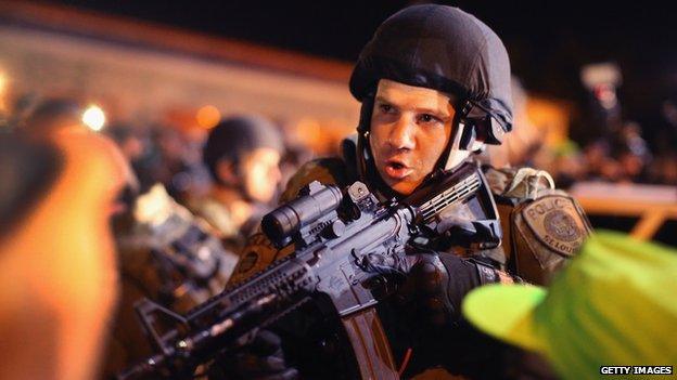 AUGUST 19: Police charge into the media work area with rifles at ready as they try to control demonstrators protesting the killing of teenager Michael Brown on August 19, 2014 in Ferguson, Missour