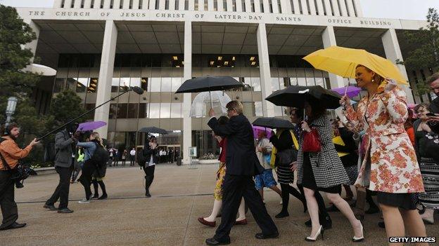 Supporters of 'Ordain Women' walk past the world headquarters of the Mormon church to march to Temple Square on April 5, 2014 in Salt Lake City, Utah to request entrance to the Mormon churches all male priesthood session.