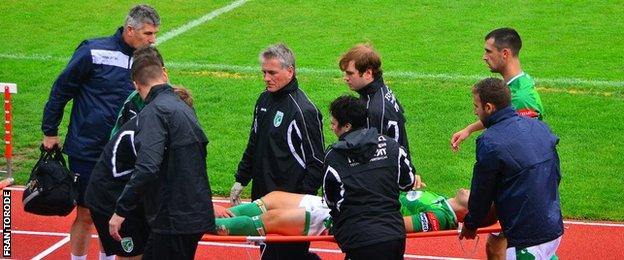 Simon Geall is stretchered off