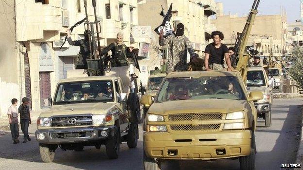 Islamic State fighters parade through the Syrian city of Raqqa (30 June 2014)