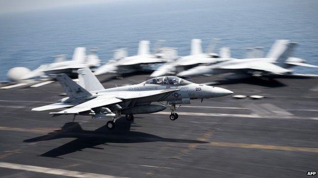 An F/A-18C Hornet returning from Iraq lands on USS George H W Bush (15 August 2014)