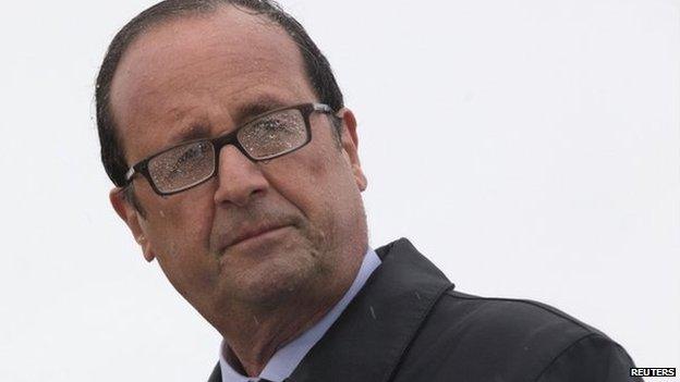 French President Francois Hollande delivers a speech in the rain on the Ile de Sein, an island located near the Pointe-du-Raz, off the Brittany coast, on 25 August 2014.