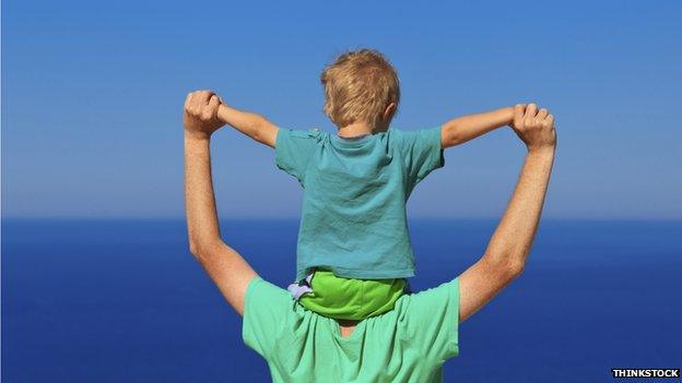 Dad holding small child