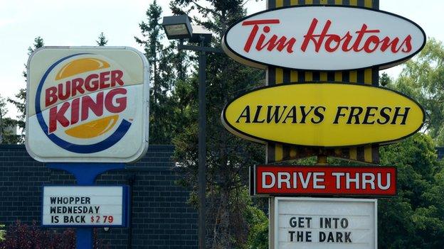 A Burger King sign stands next to one for Tim Hortons.