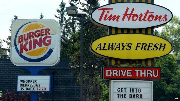 A Burger King sign stands next to one for Tim Hortons.