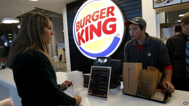 A woman orders at a Burger King counter