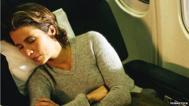 Woman asleep on plane