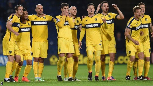 Oxford United's players watch on during the penalty shootout