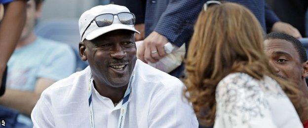 Michael Jordan chats to Mirka Federer during Roger Federer's first-round match