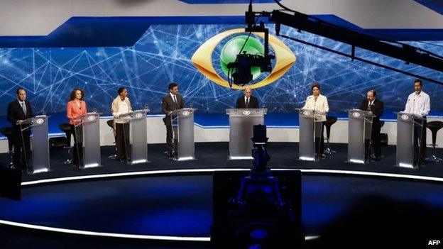 Brazilian presidential candidates for the Social Christian Party, Pastor Everaldo (L), for the Socialism and Freedom Party Luciana Genro (2-L), for the Brazilian Socialist Party Marina Silva (3-L), for the Brazilian Social Democracy Party Aecio Neves (4-L), for the Brazilian Labour Renewal Party Levy Fidelix (2-R), for the Green Party Eduardo Jorge (R), host Ricardo Boechat (4-R) and Brazilian President and candidate for the Workers" Party Dilma Rousseff (3-R), attend a television debate in Sao Paulo, Brazil on July 26, 2014. Brazilian general elections will take place next October 5.