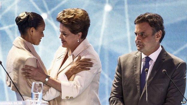 Marina Silva (left) greets President Dilma Rousseff as Aecio Neves watches before a television debate in Sao Paulo on 26 July, 2014