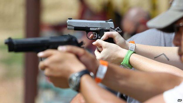 Shooters practice with pistols at a gun range