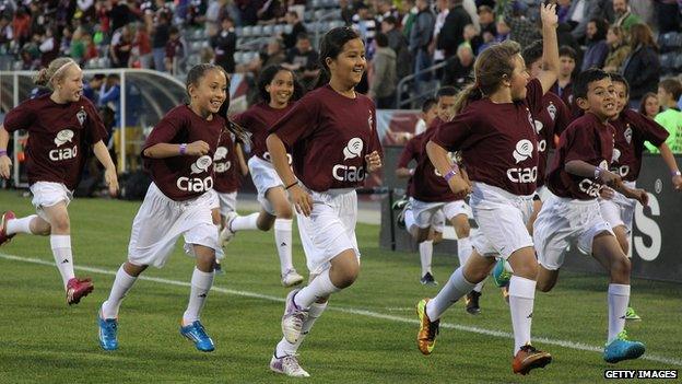 Young Colorado Rapids supporters take the field as the Rapids face the the Montreal Impact at Dick's Sporting Goods Park in Commerce City, Colorado 24 May 2014