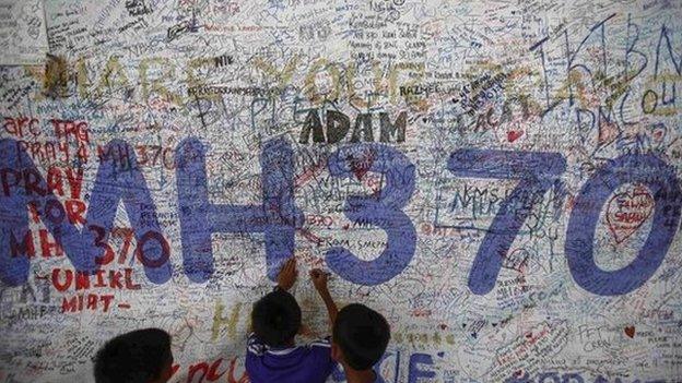 Children write messages of hope for passengers of missing Malaysia Airlines Flight MH370 at Kuala Lumpur International Airport (KLIA) outside Kuala Lumpur 14 June 2014