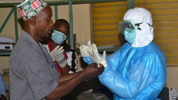 Health workers take off their protective suits as they finish their shifts at Pita hospital in Guinea - 25 August 2014