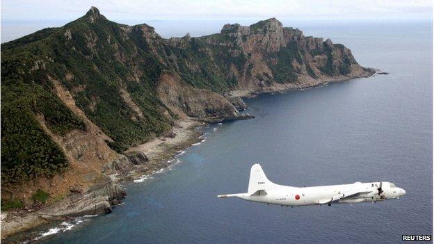 Japan Maritime Self-Defence Force's PC3 surveillance plane flies around the disputed islands in the East China Sea, known as the Senkaku isles in Japan and Diaoyu in China, in this 13 October 2011 file photo